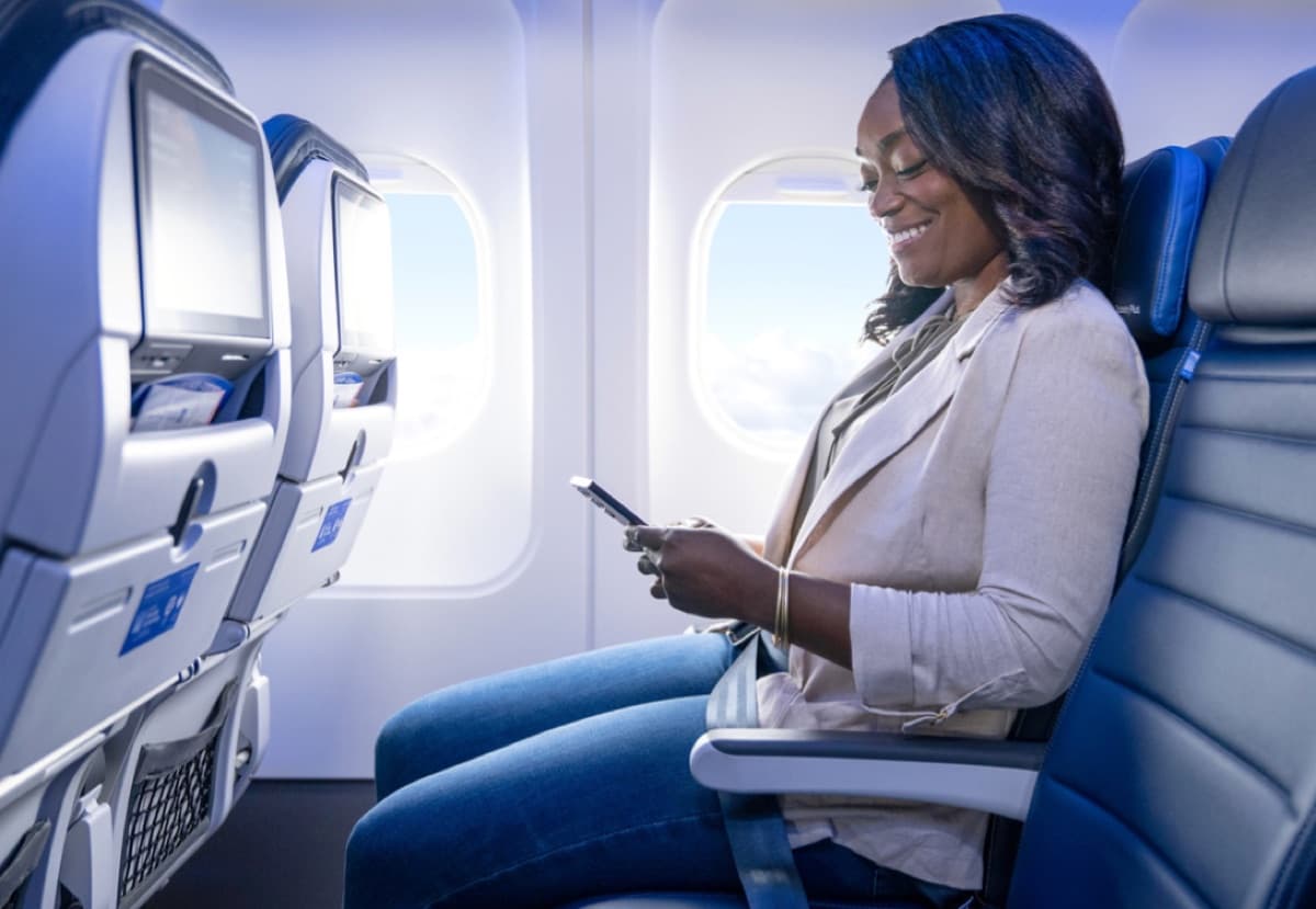 United Airlines economy cabin with seatback screen and window seat